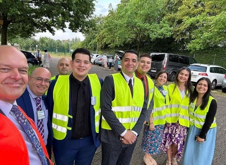Volunteers and congregation members gathered outdoors in a visible service role.